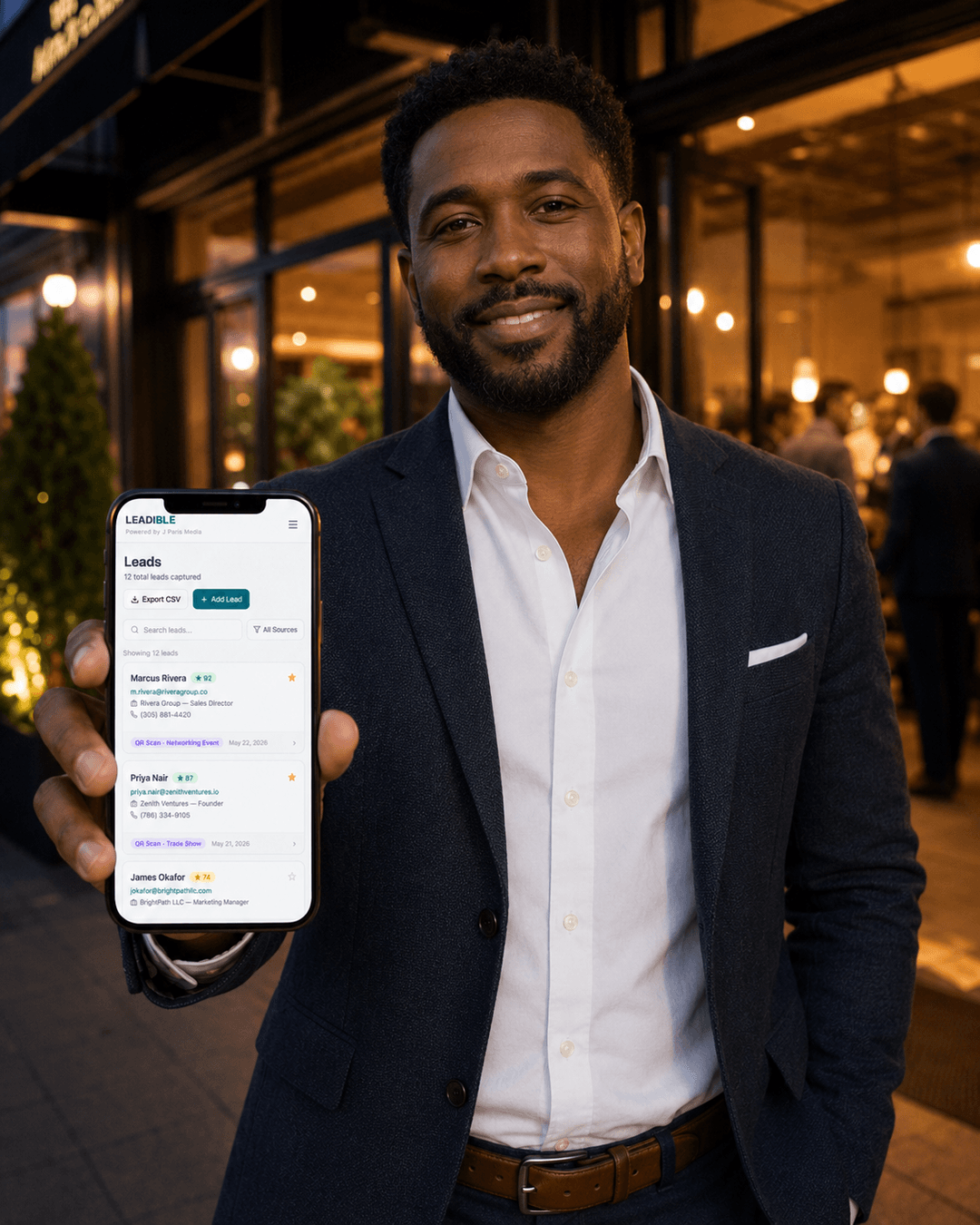 Business owner checking new leads on their phone after an event